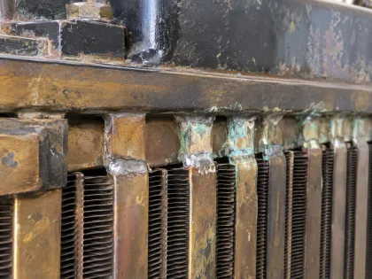 corroded tube-to-header joints on a radiator